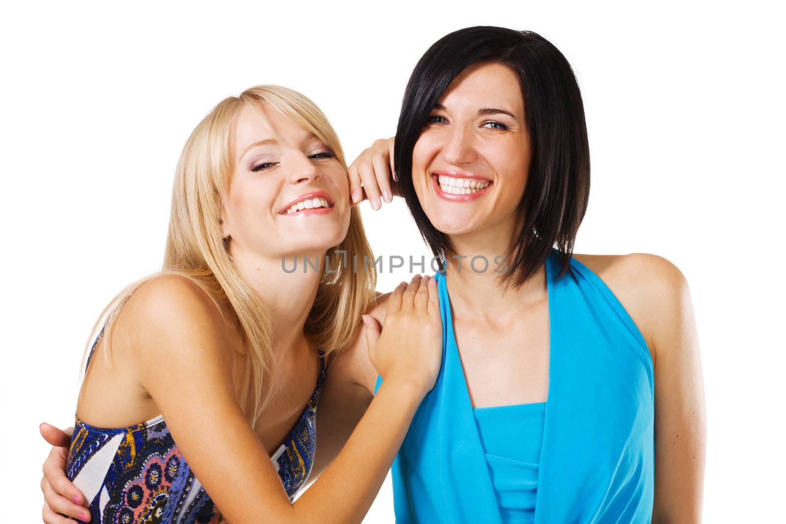 Studio portrait of two young beautiful friends, white background 