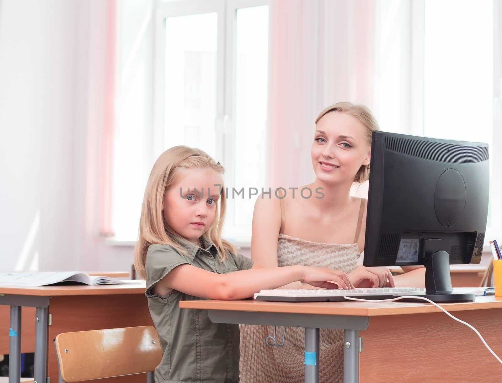 teacher explains the task schoolgirl at the computer, the new technologies in education