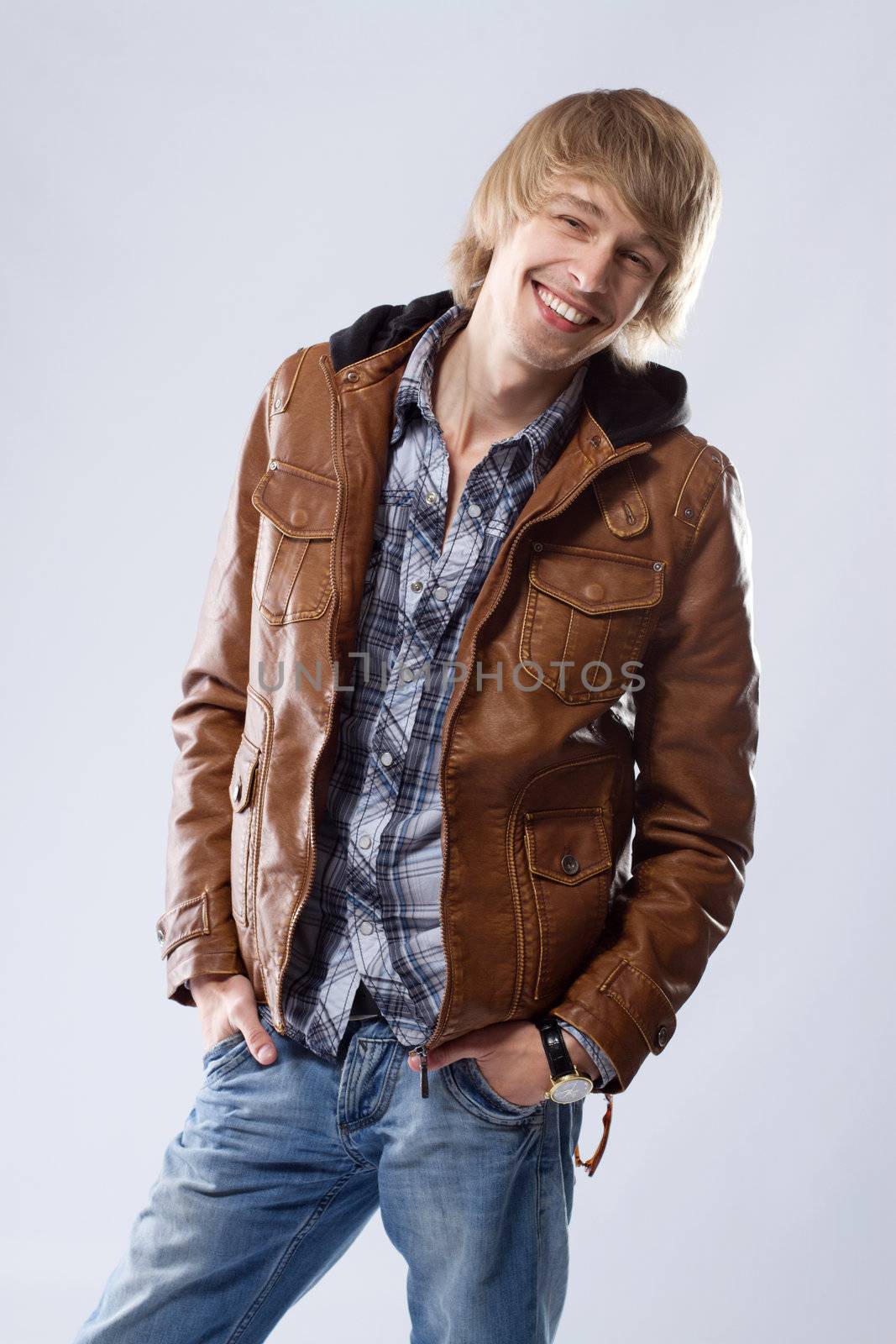 Handsome young man in leather jacket, studio portrait