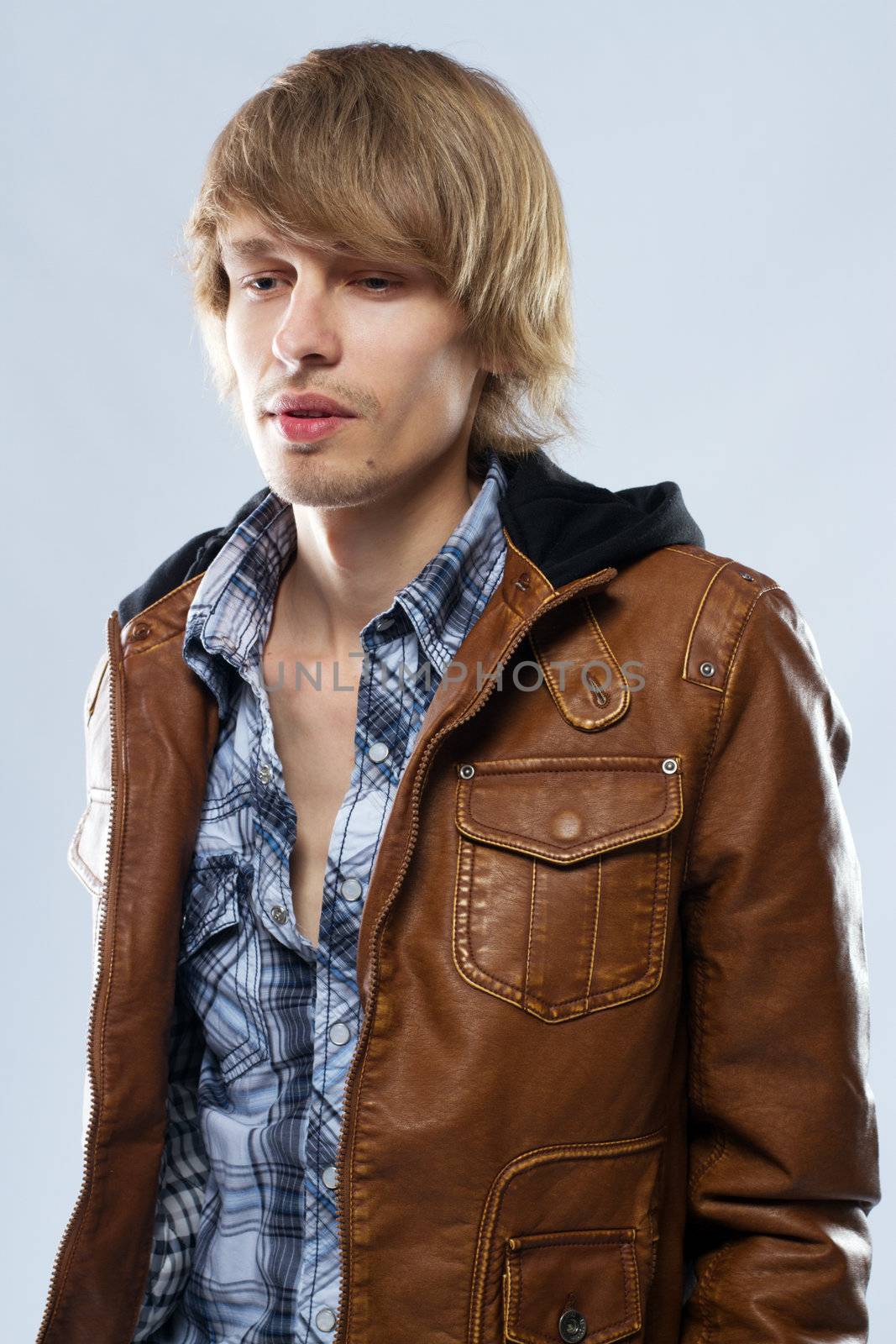 Handsome young man in leather jacket, studio portrait