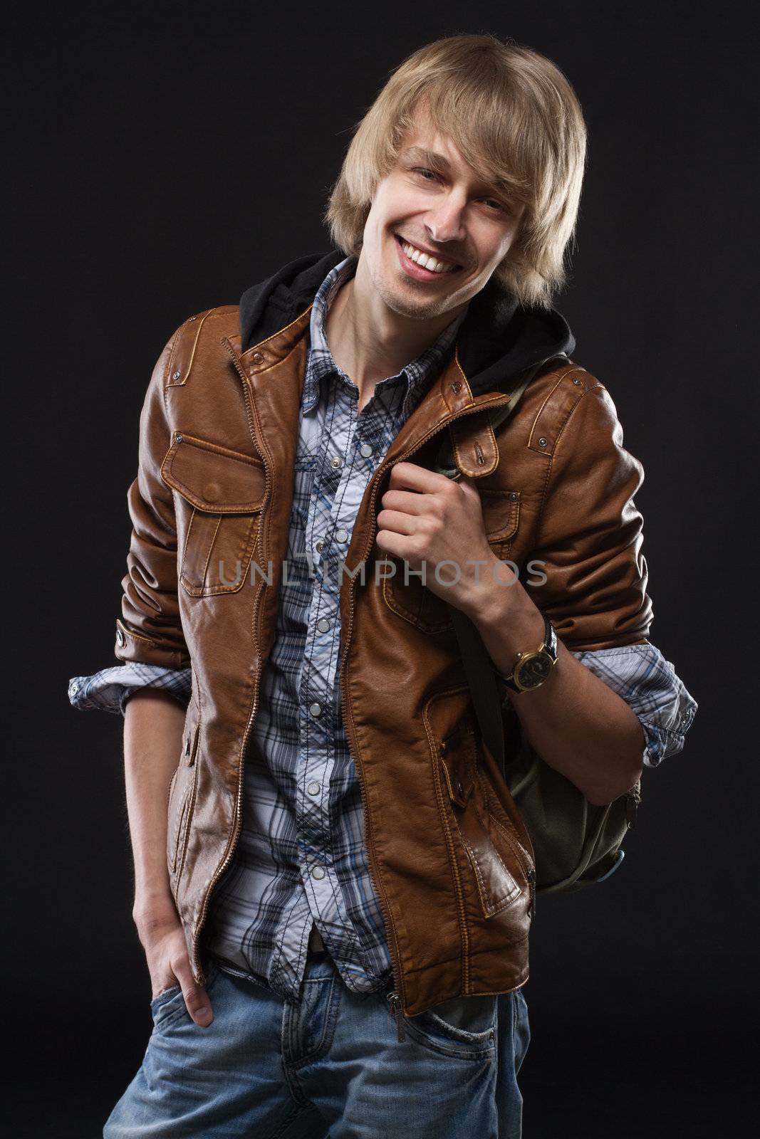 Handsome young man in leather jacket, studio portrait