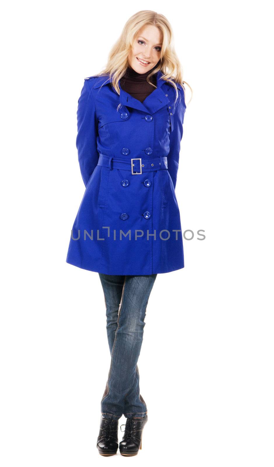 Pretty model in a blue coat against white background 