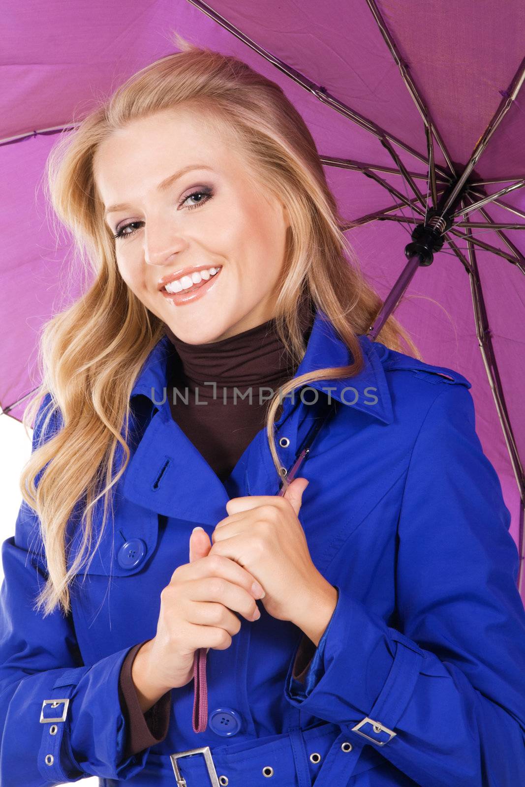 Portrait of a pretty model in blue coat holding a violet umbrella