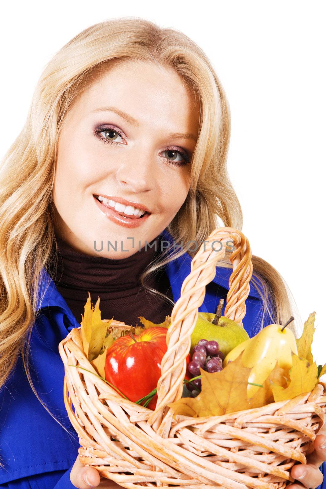Portrait of lovely woman with a basket of ripe fruits