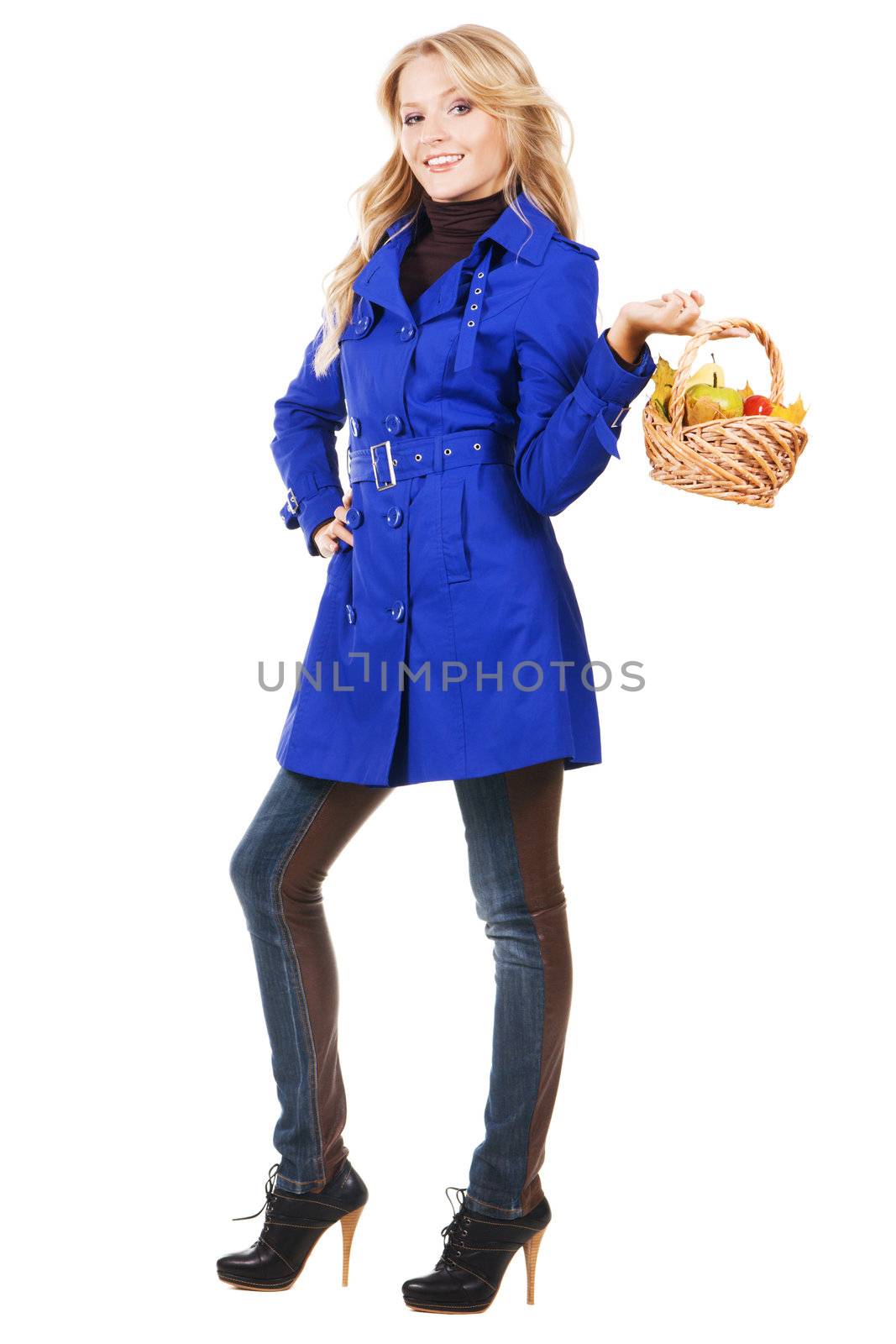 Cheerful girl with a basket of ripe fruits, white background 