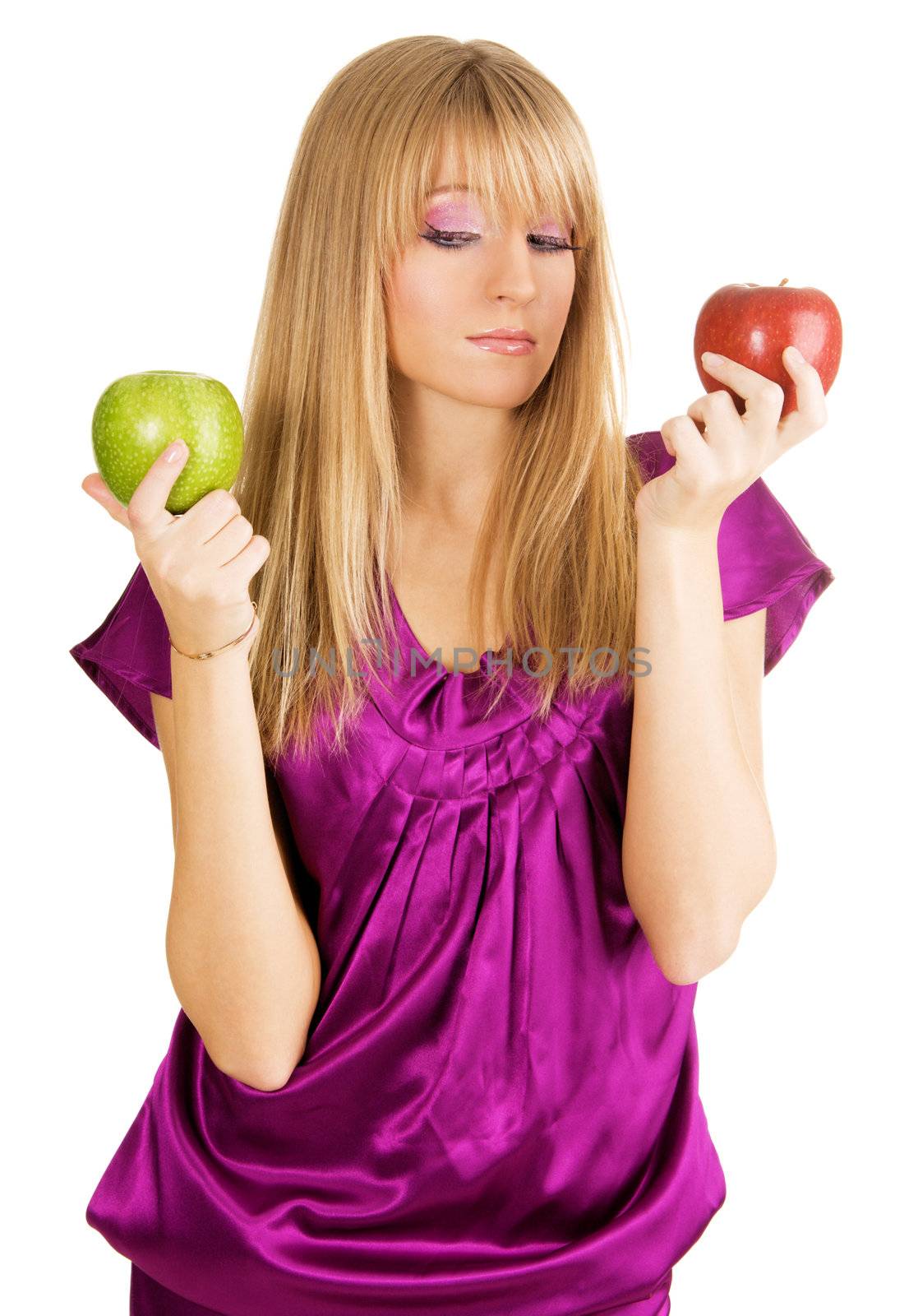 Beautiful girl weighing two fresh apples