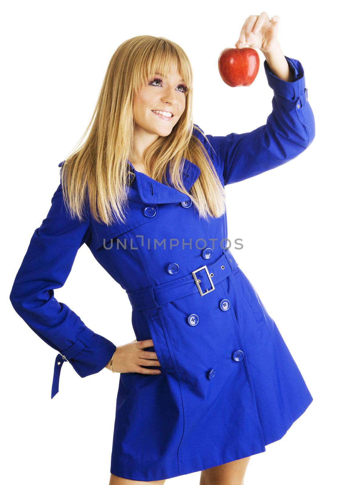 Young woman in blue autumn coat holding a red apple