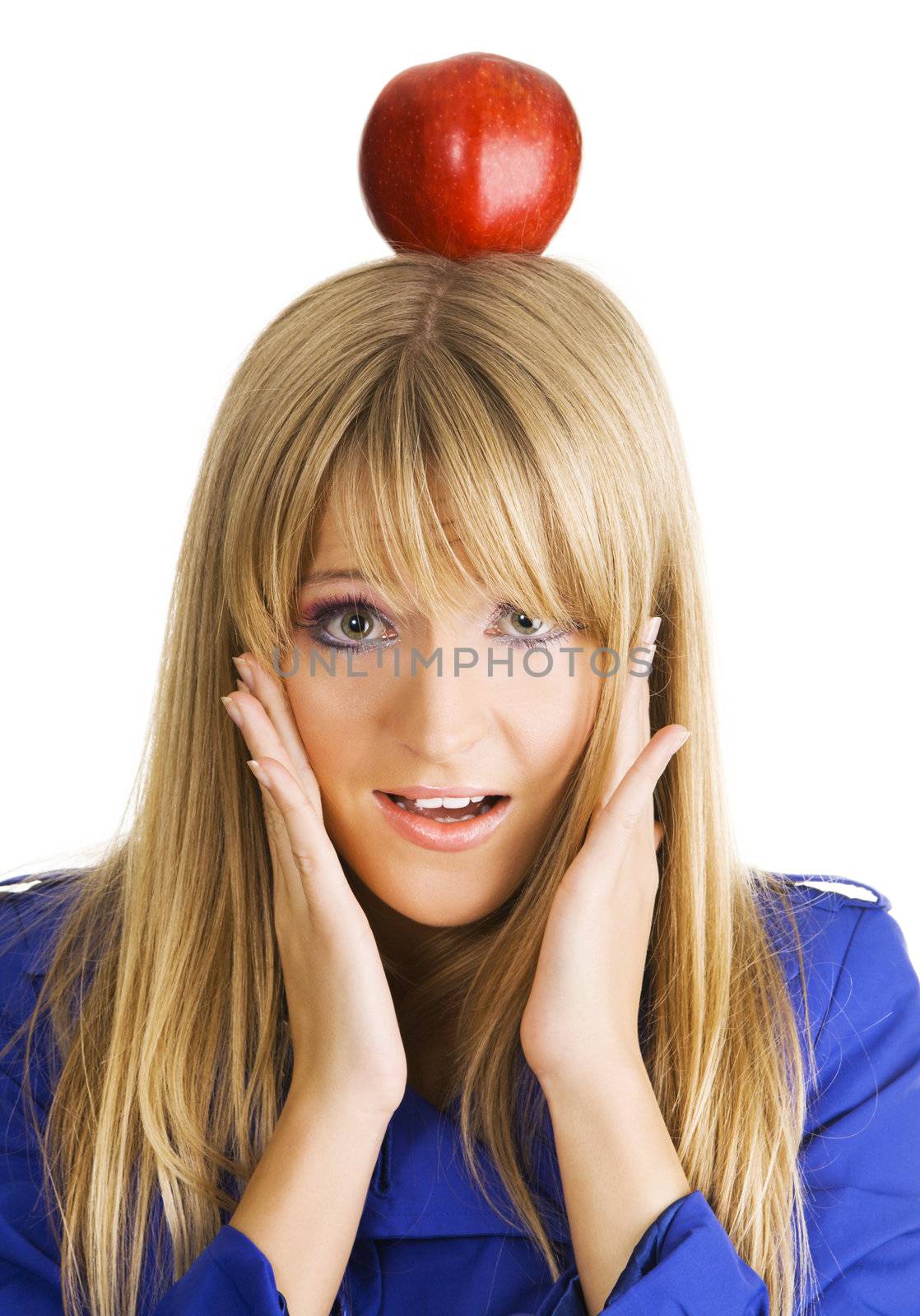 Funny frightened young woman with an apple on her head
