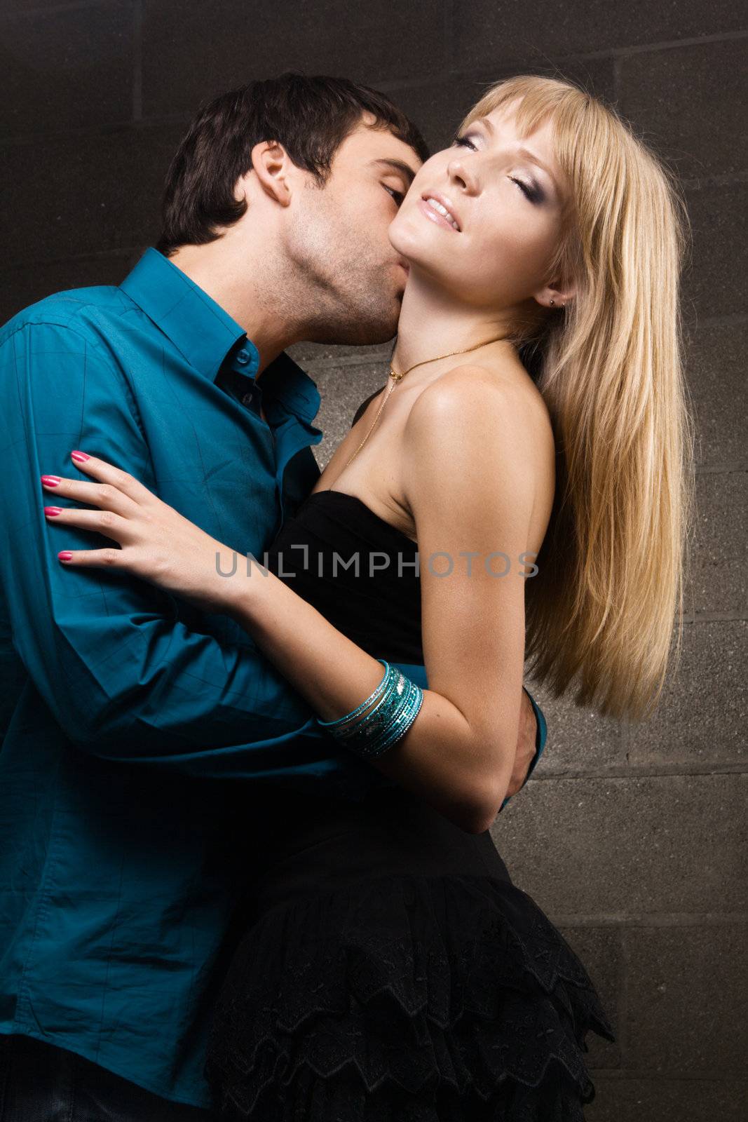 Young romantic couple kissing in house interior