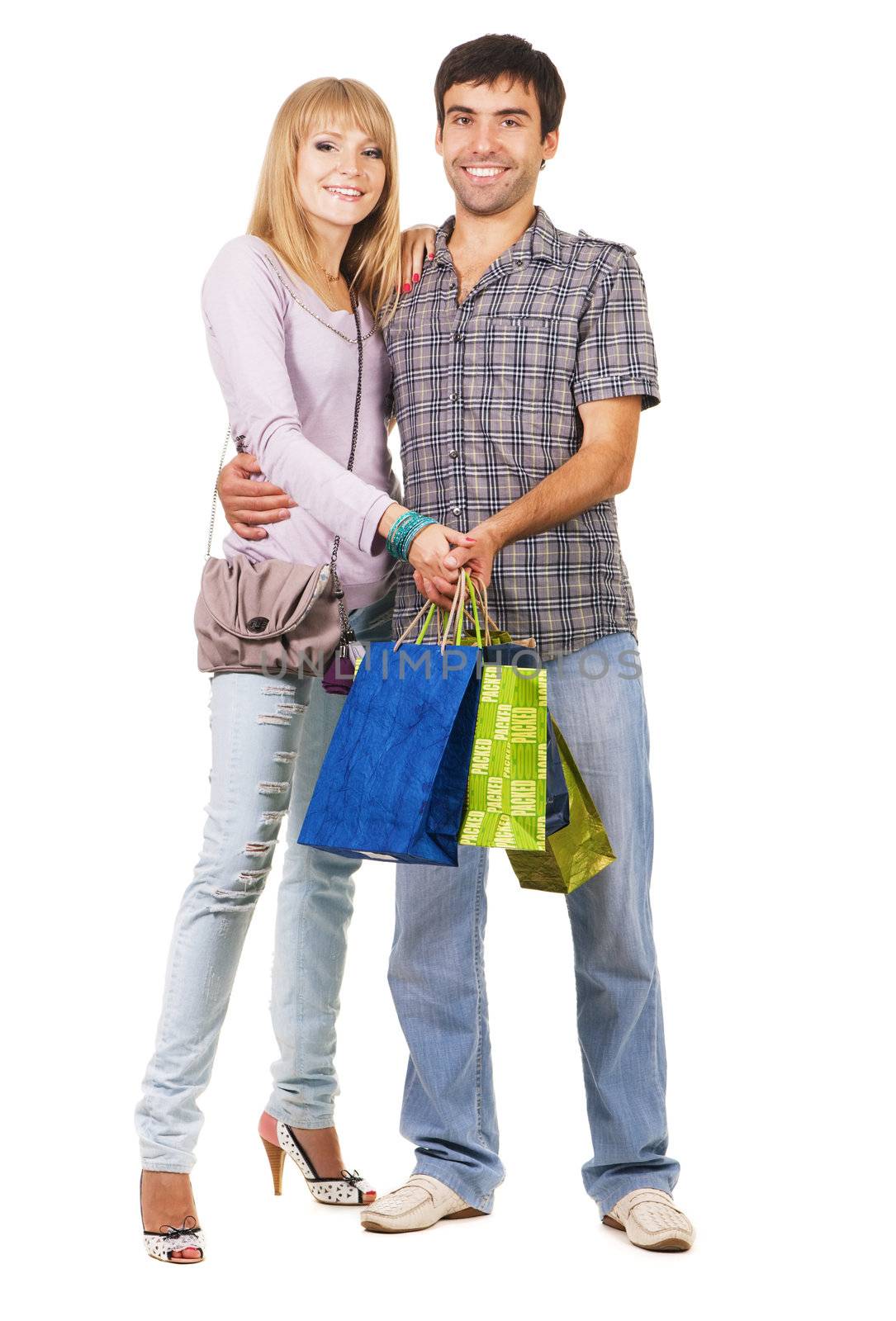 Beautiful young couple with shopping bags, isolated on white background