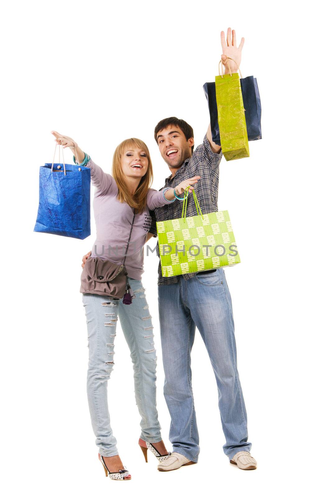 Beautiful young couple with shopping bags, isolated on white background