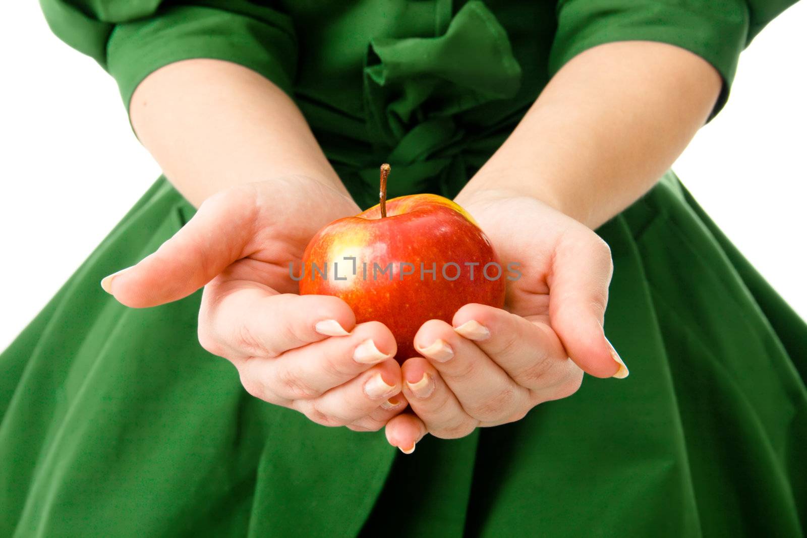 Woman's hands holding a fresh apple by Gdolgikh
