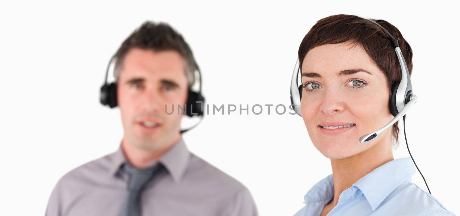 Close up of managers using headsets against a white background