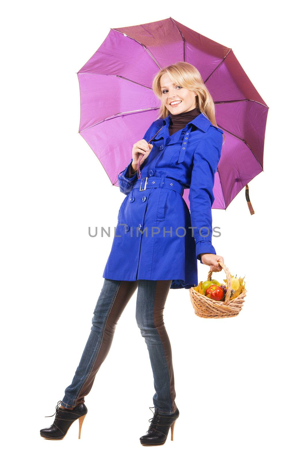 Cheerful girl with a bascket of fruit and umbrella, white backgrouna