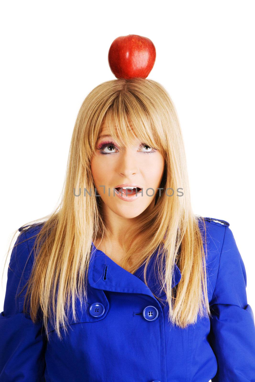 Funny frightened young woman with an apple on her head