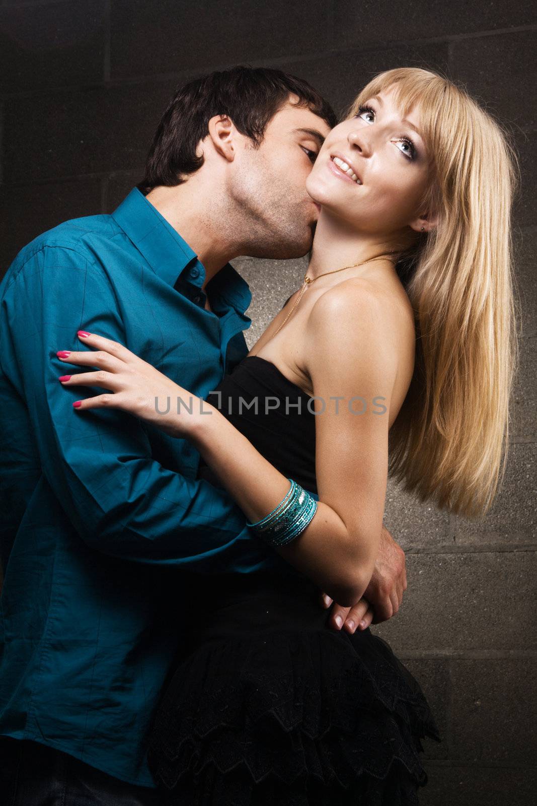 Young romantic couple kissing in house interior 