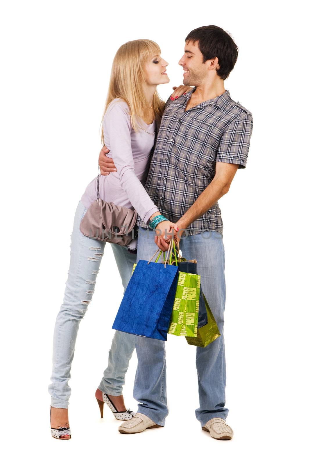 Beautiful young couple with shopping bags, isolated on white background