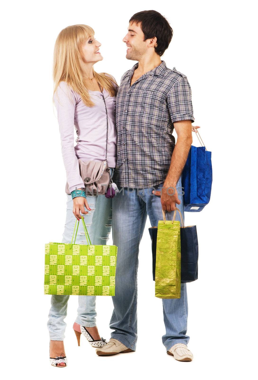 Beautiful young couple with shopping bags, isolated on white background 