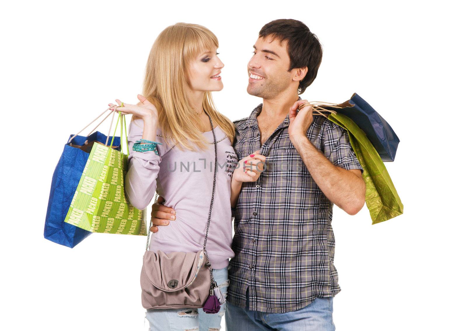 Cheerful young couple with shopping bags, isolated on white background 