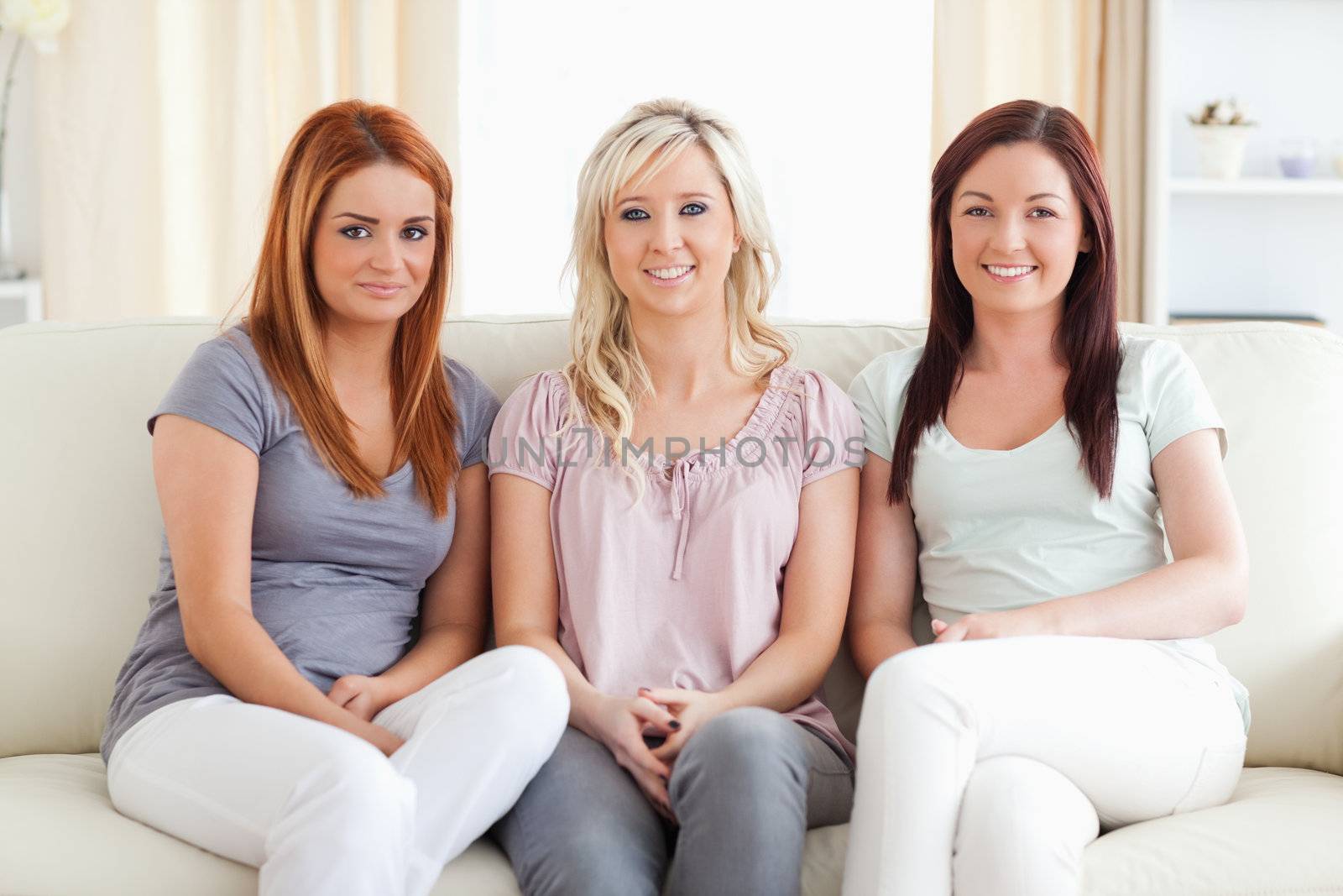Friends sitting on a sofa in a living room