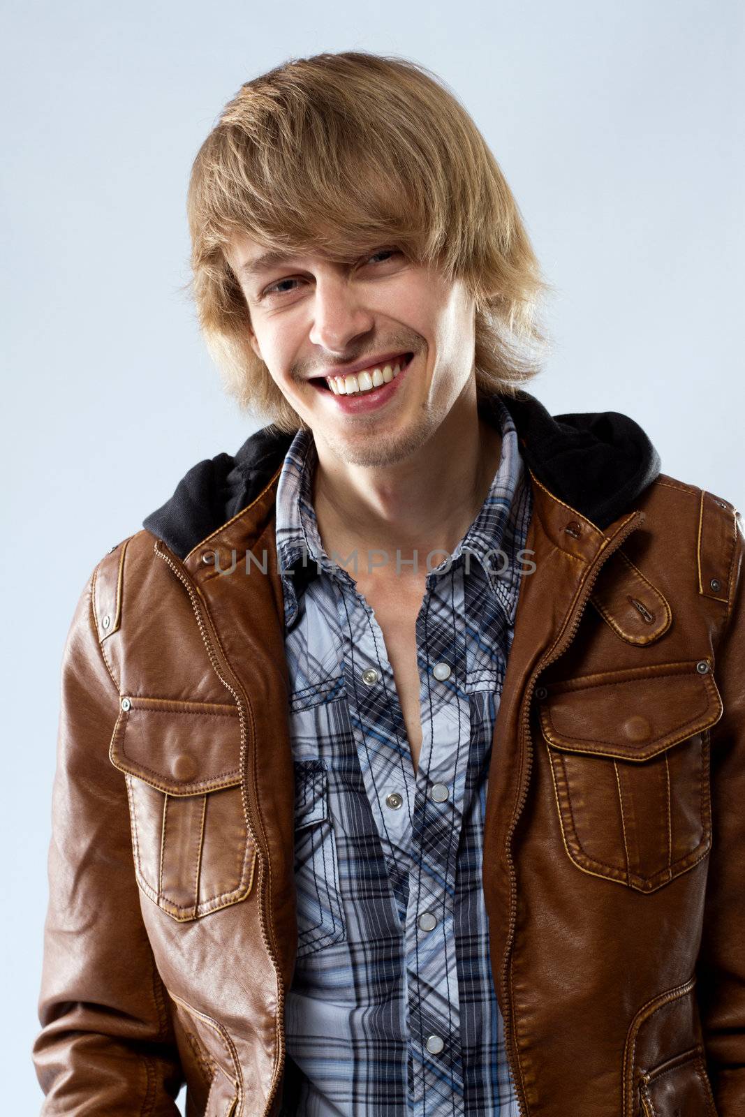 Handsome young man in leather jacket, studio portrait