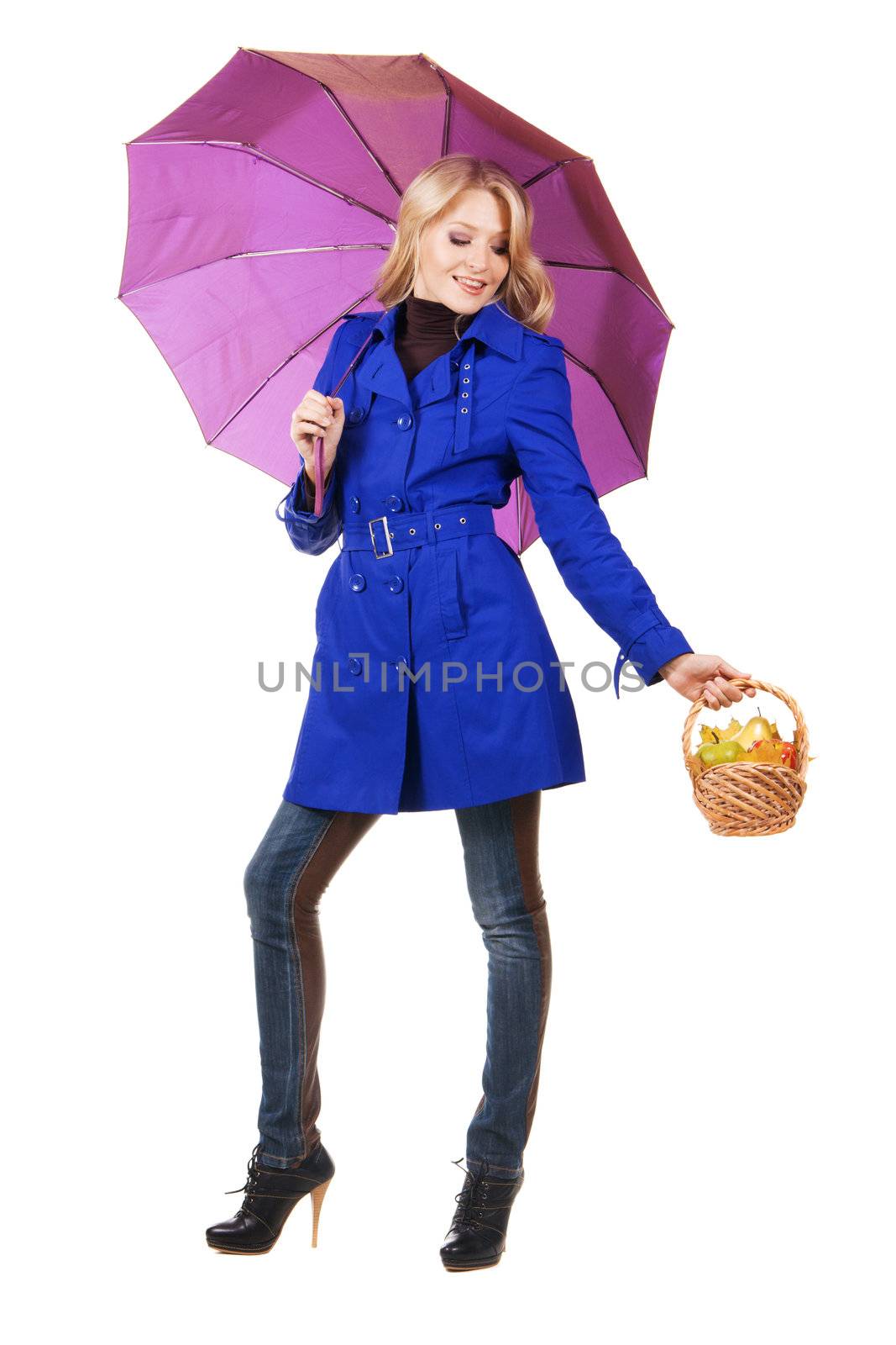 Cheerful girl with a basket of fruit and umbrella, white background 
