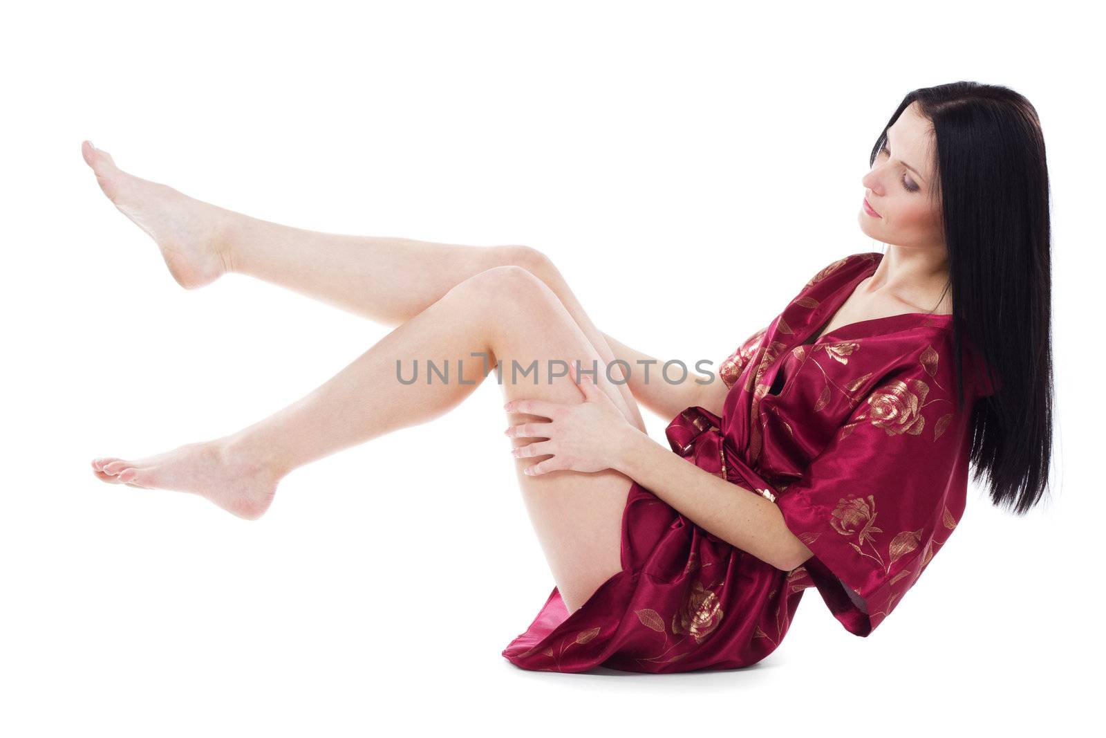 Beautiful woman taking care of her attractive legs, isolated on white