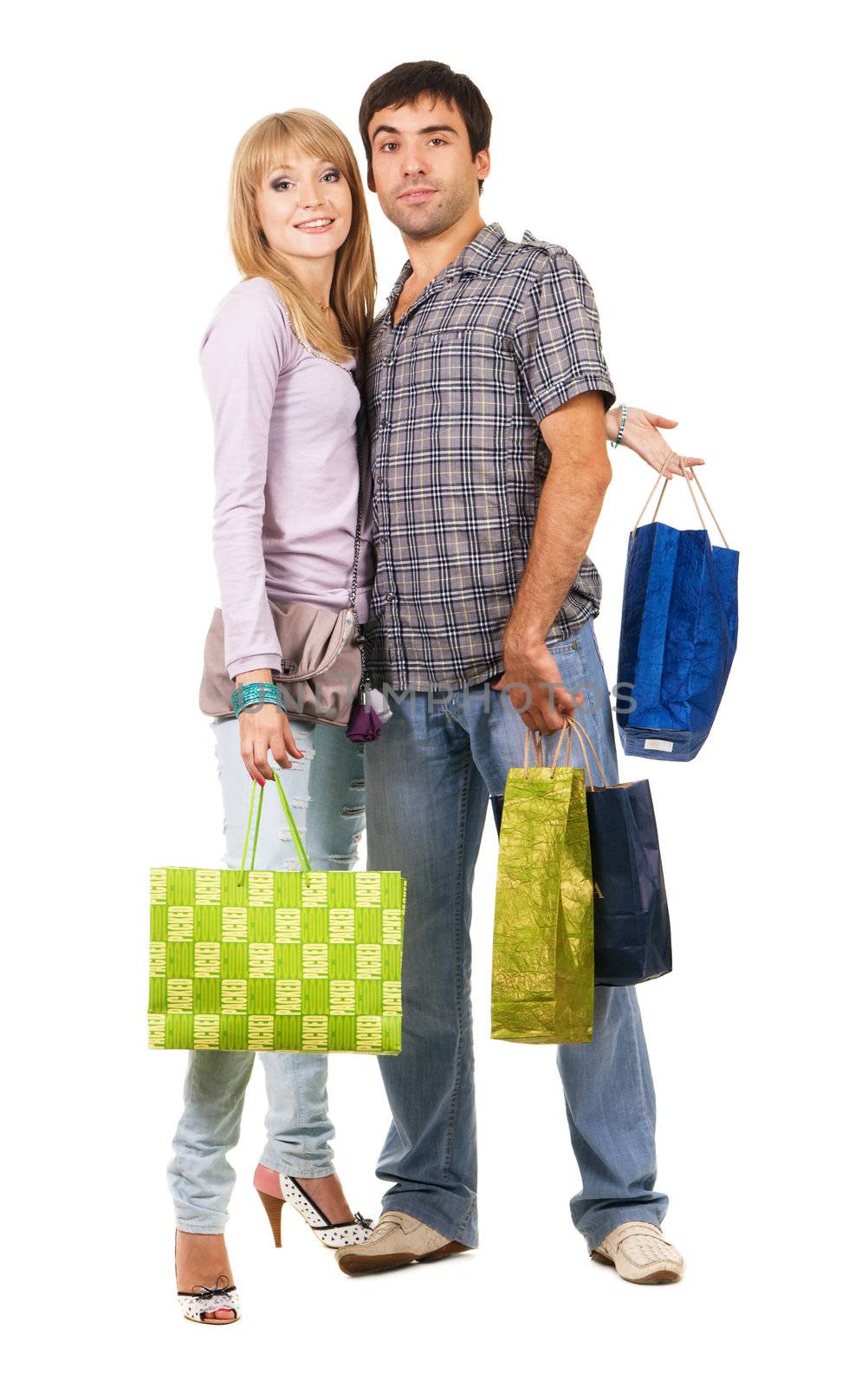 Beautiful young couple with shopping bags, isolated on white background 