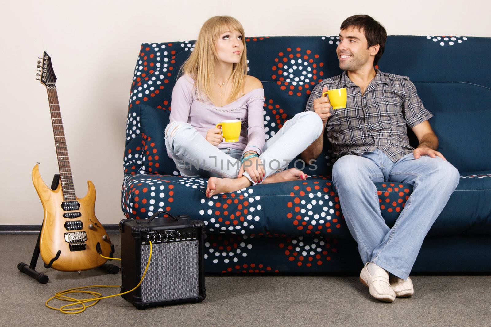 Cheerful couple resting on a sofa