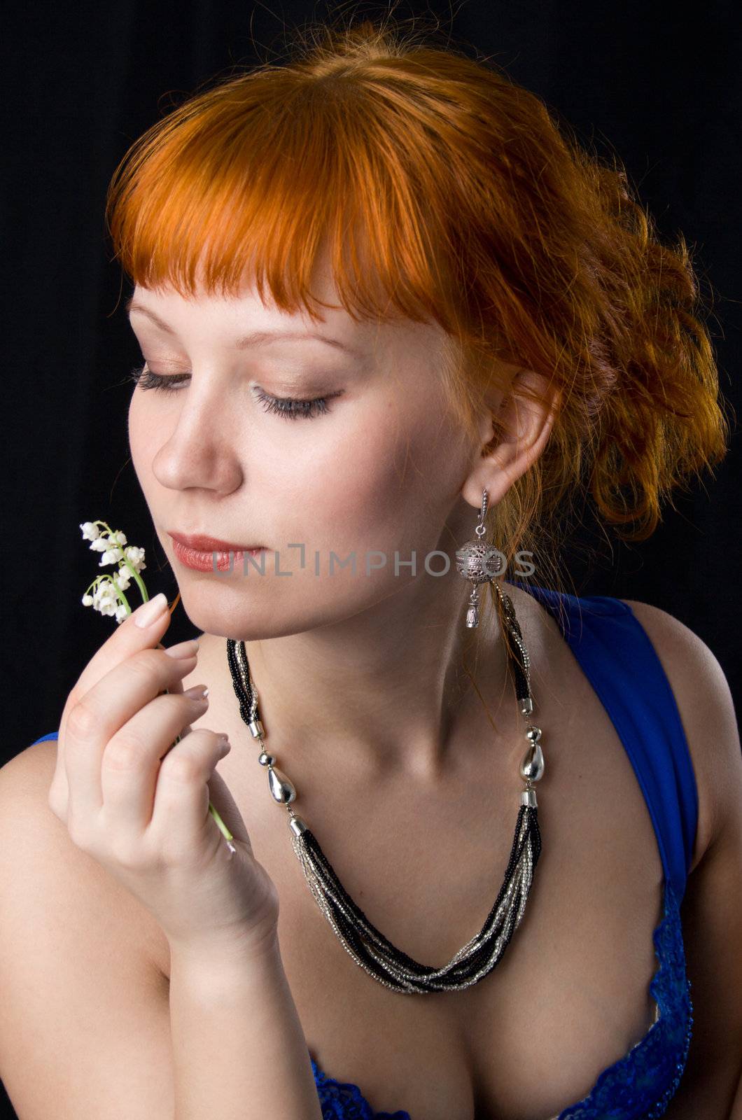 Beautiful lady smelling flowers