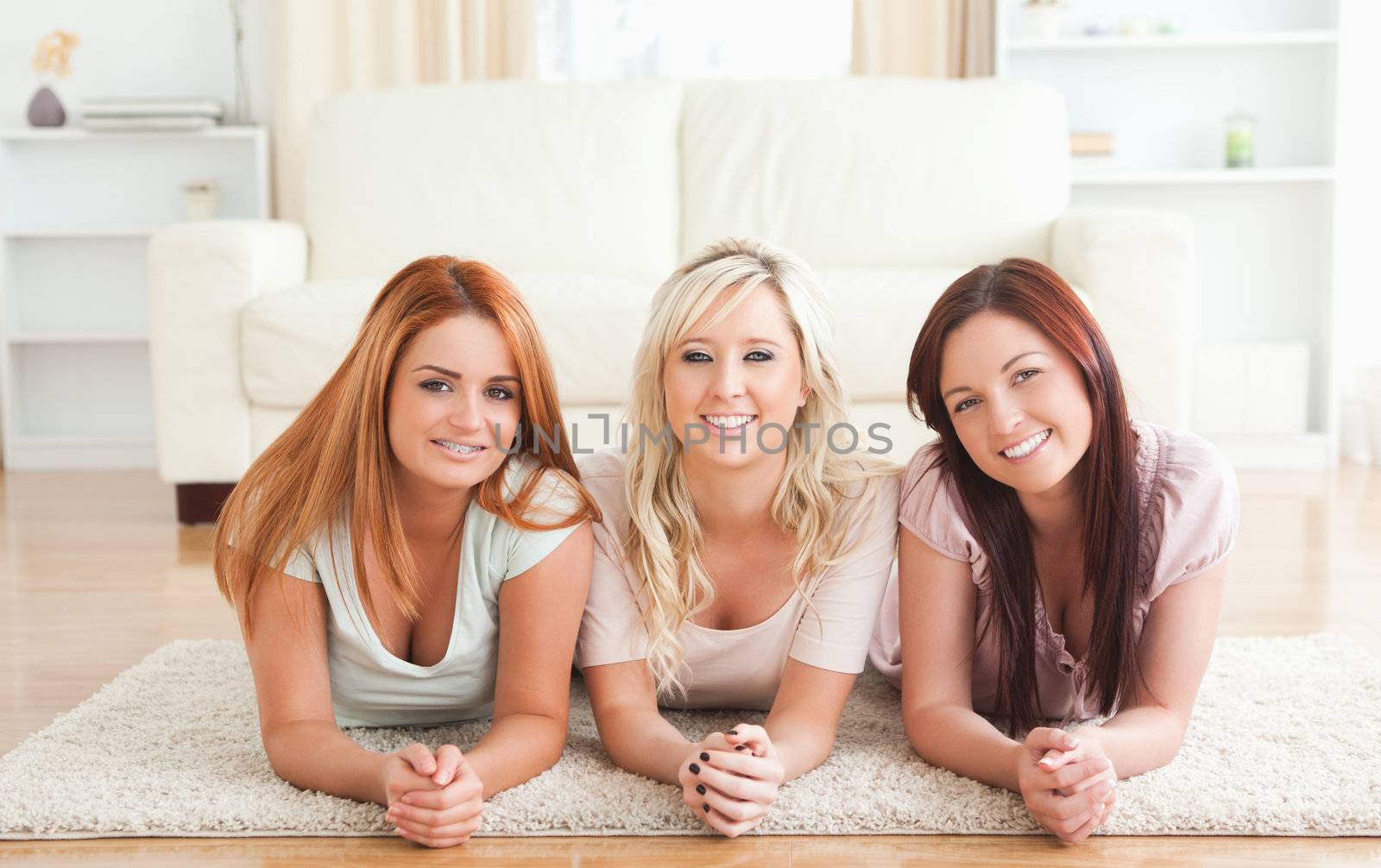 Girlfriends lying on the floor in a living room