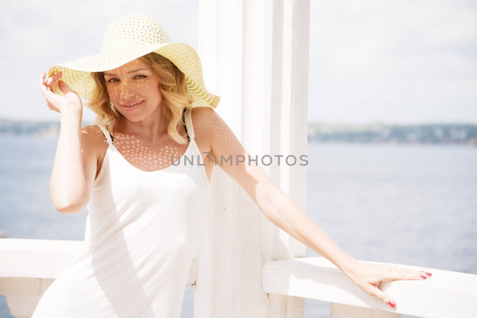 Beautiful lady in a hat on a sunny day