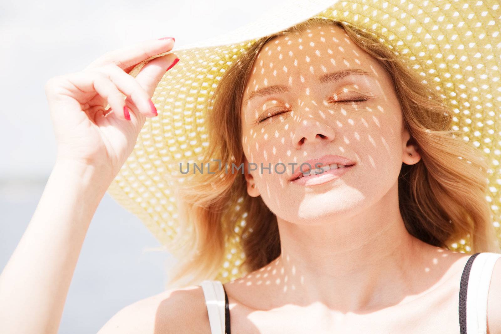 Beautiful lady in a hat on a sunny day