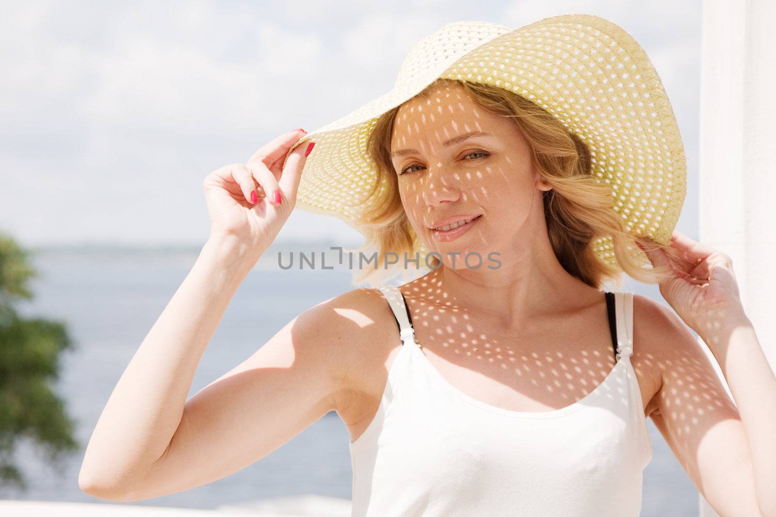 Beautiful lady in a hat on a sunny day