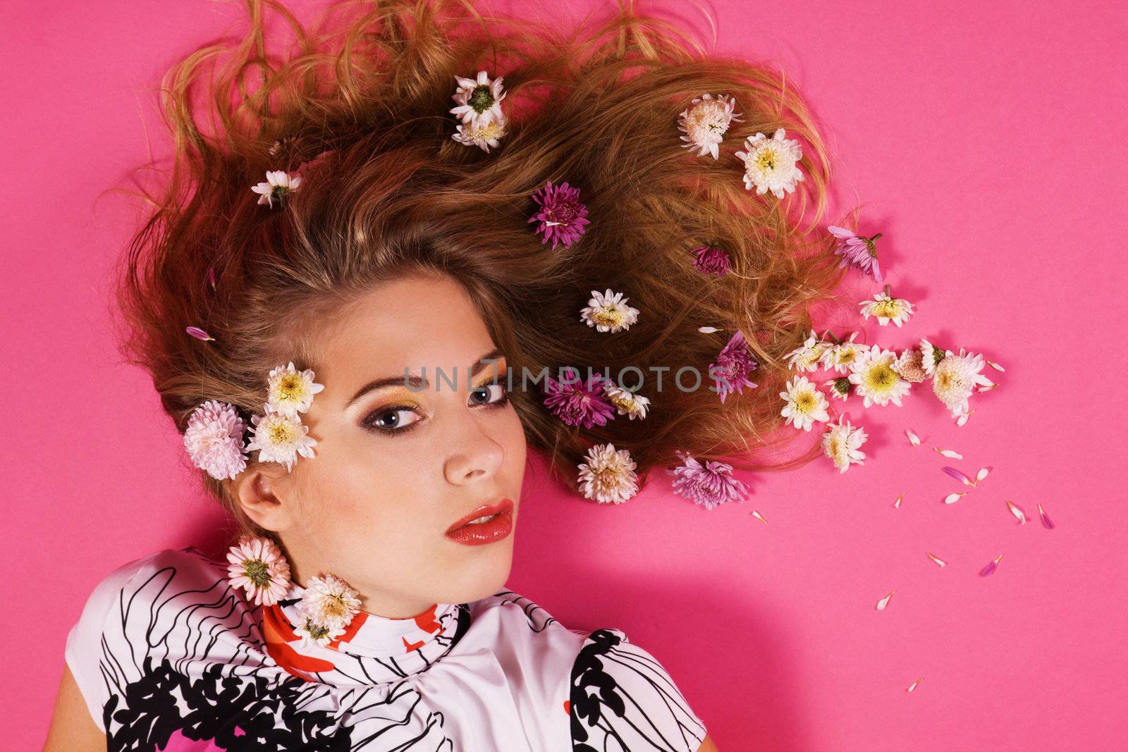 Face portrait of a beautiful fashion model with flowers in hair  