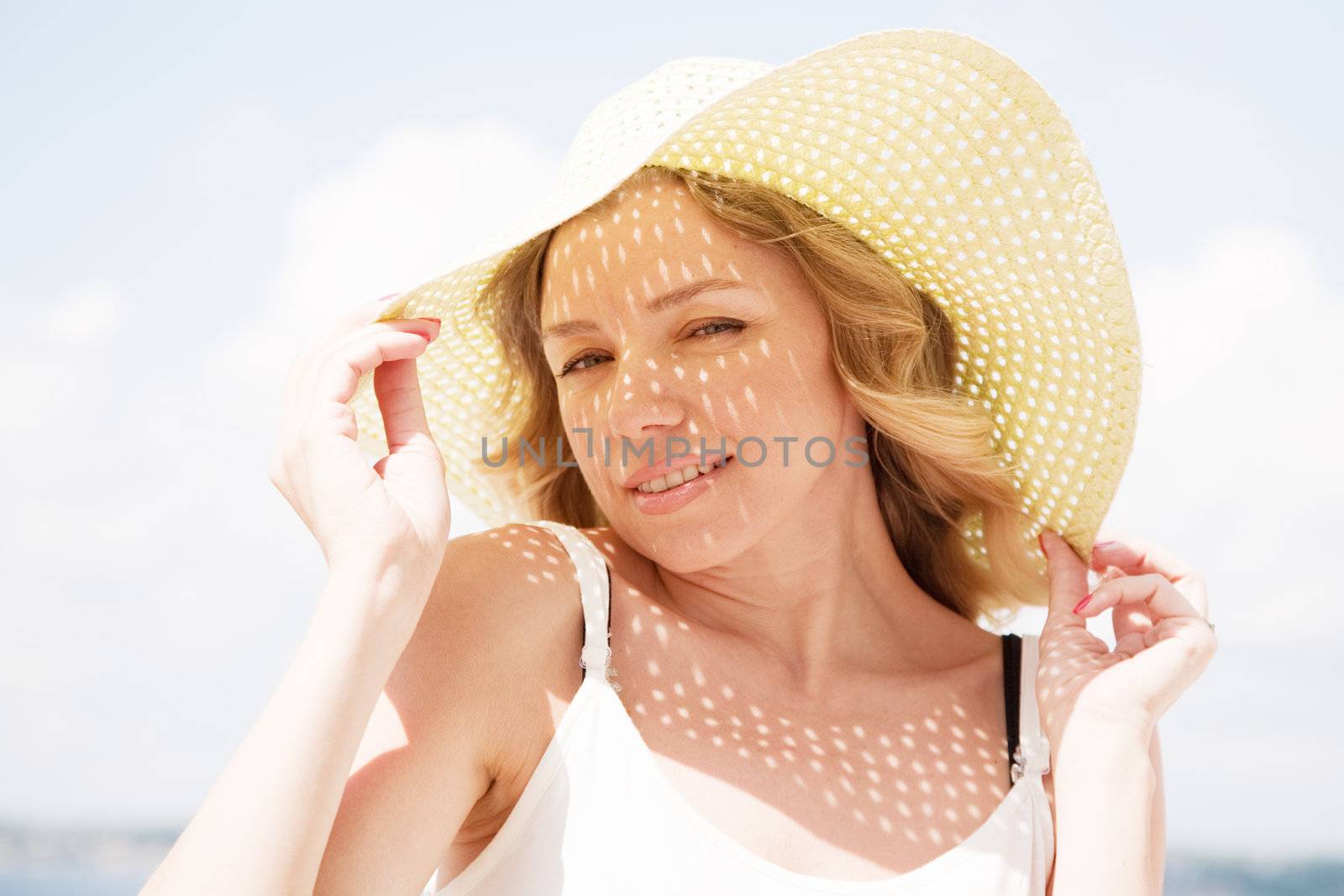 Beautiful lady in a hat on a sunny day