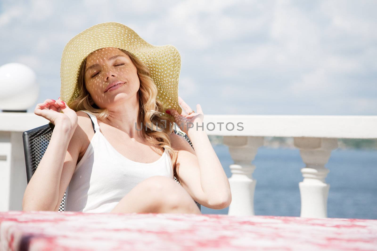 Beautiful lady in a hat on a sunny day