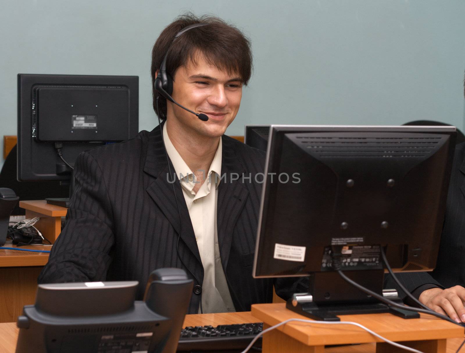 Young businessman in his office, working with the computer