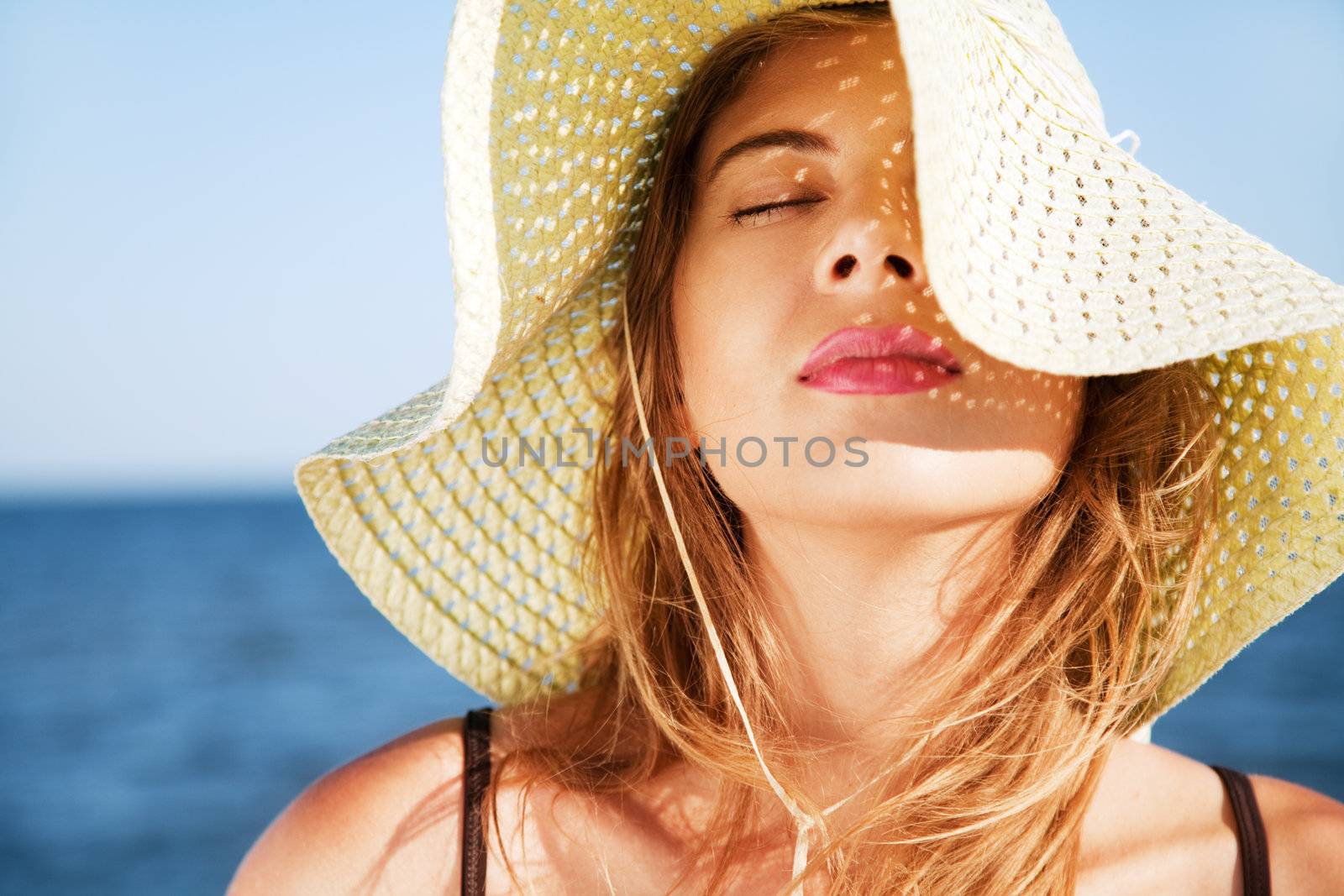 Beautiful woman on a beach by Gdolgikh