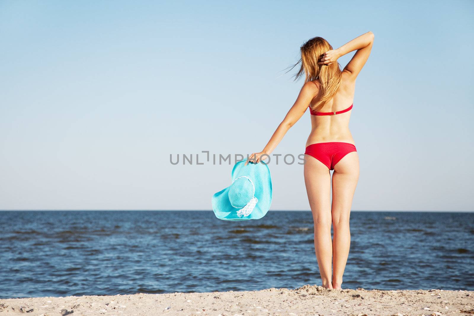 Beautiful woman on a beach by Gdolgikh