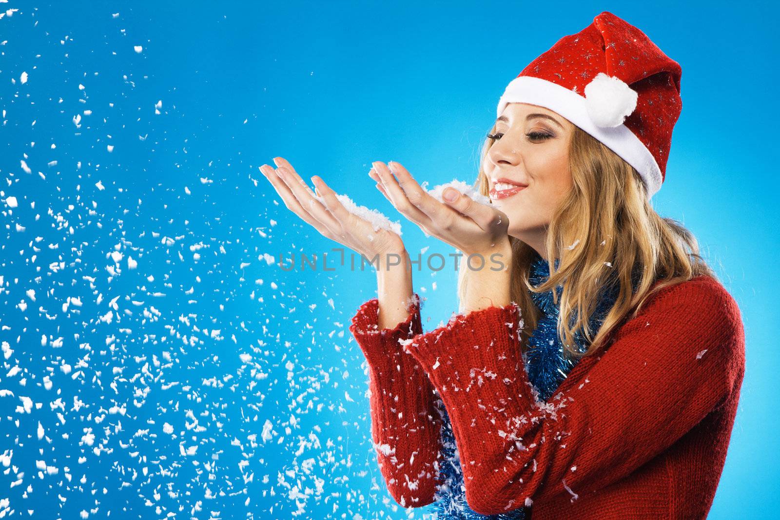 Lovely girl with a palms full of snow