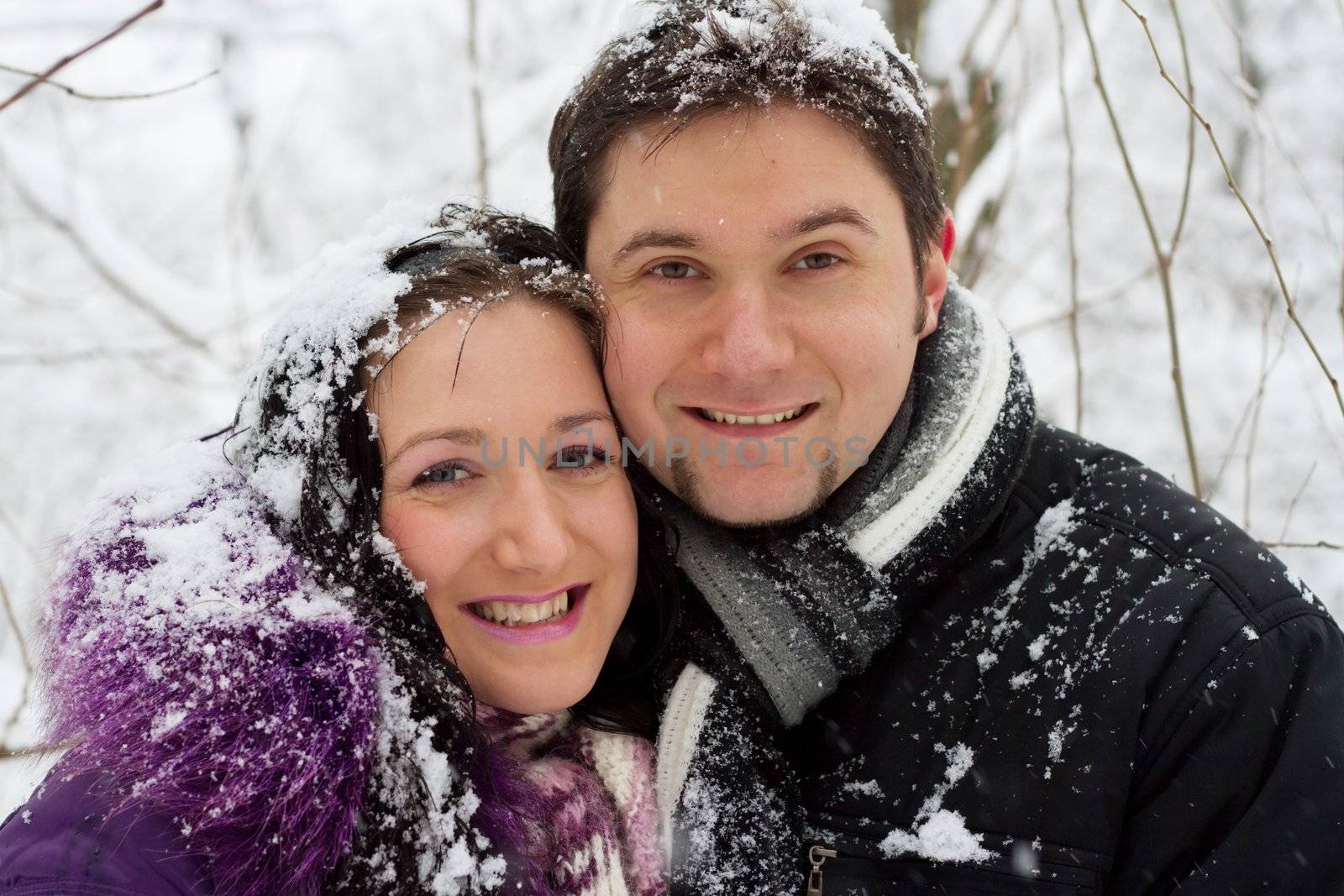 Portrait of a young happy couple in winter park
