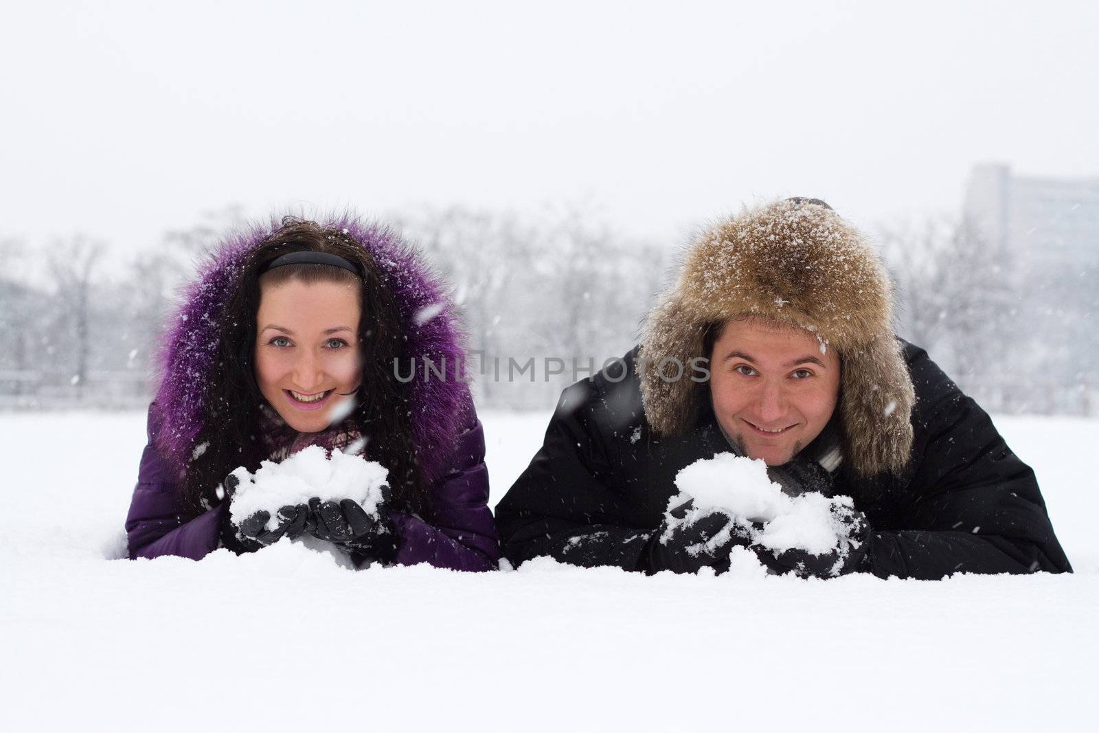 Portrait of young couple having fun in winter park