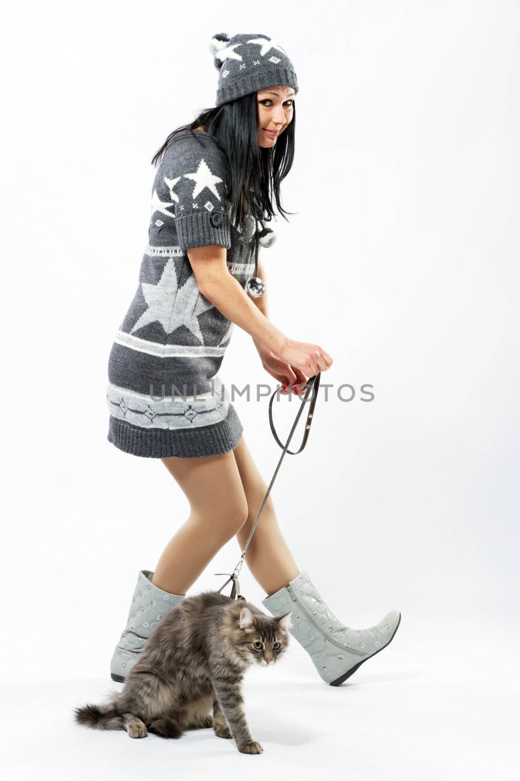 Young lady with a cat, studio photo on neutral backgrund