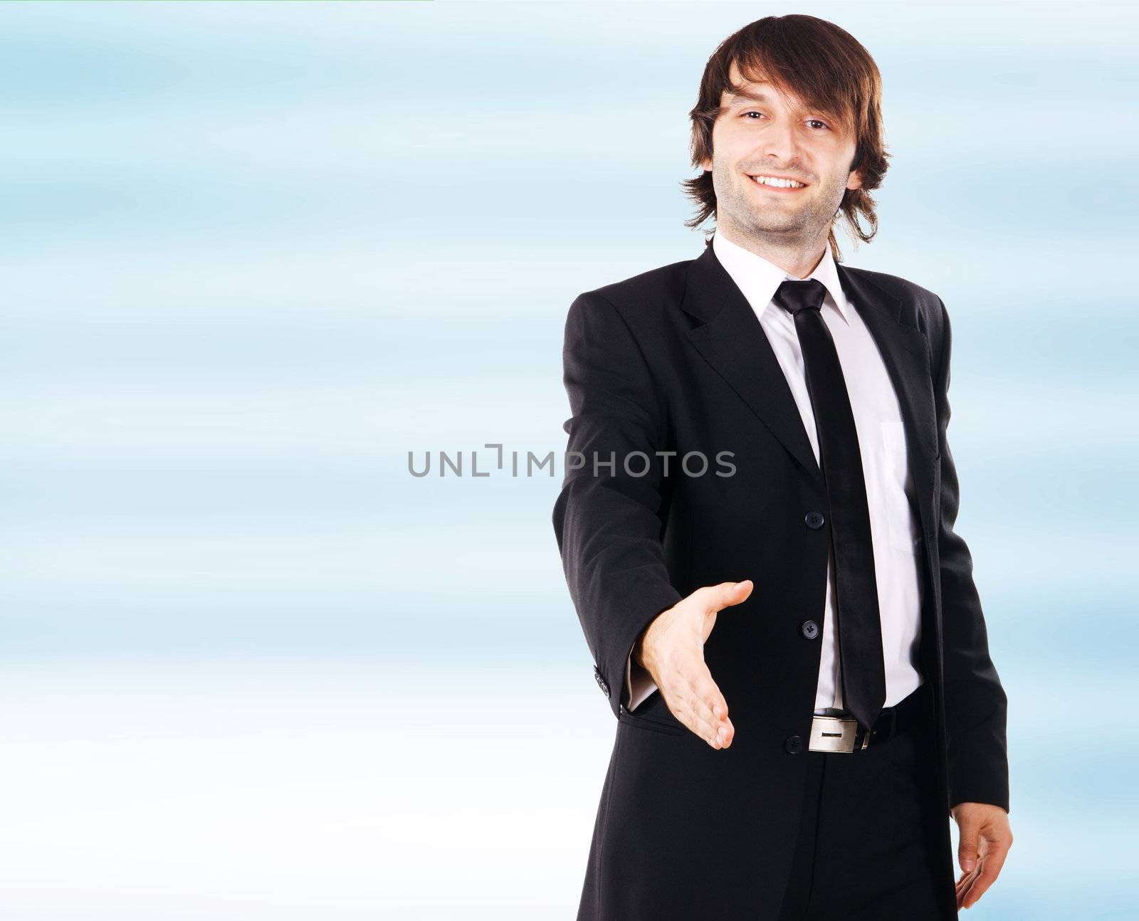 Young elegant businessman reaching open hand, white background 
