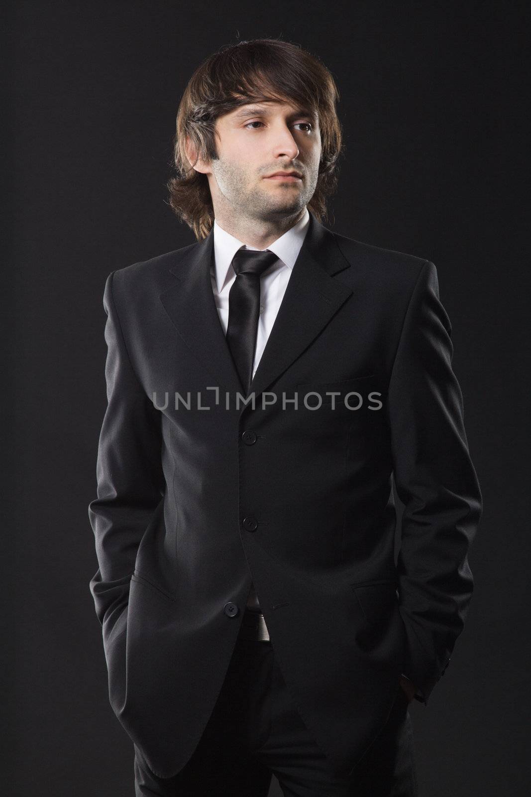 Handsome young man in business suit, studio photo