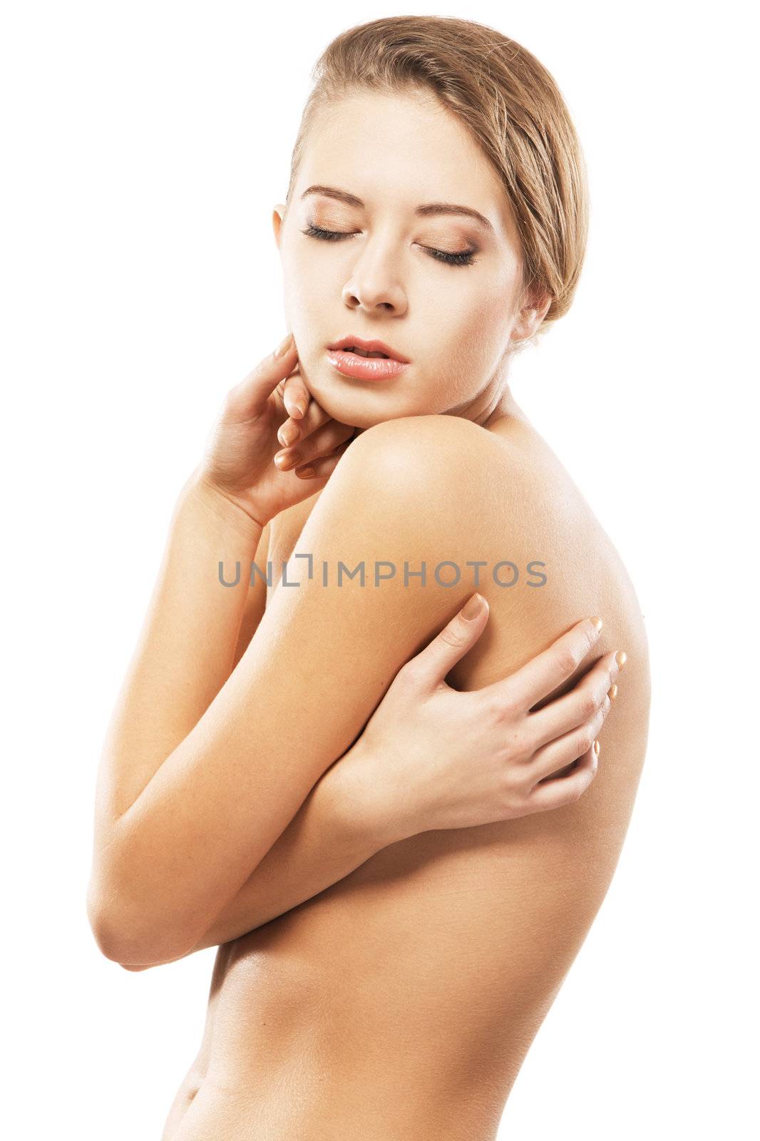 Portrait of a beautiful naked young woman, gray background 
