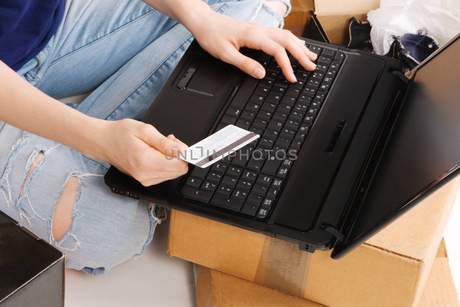 Young girl entering her credit card info in online store