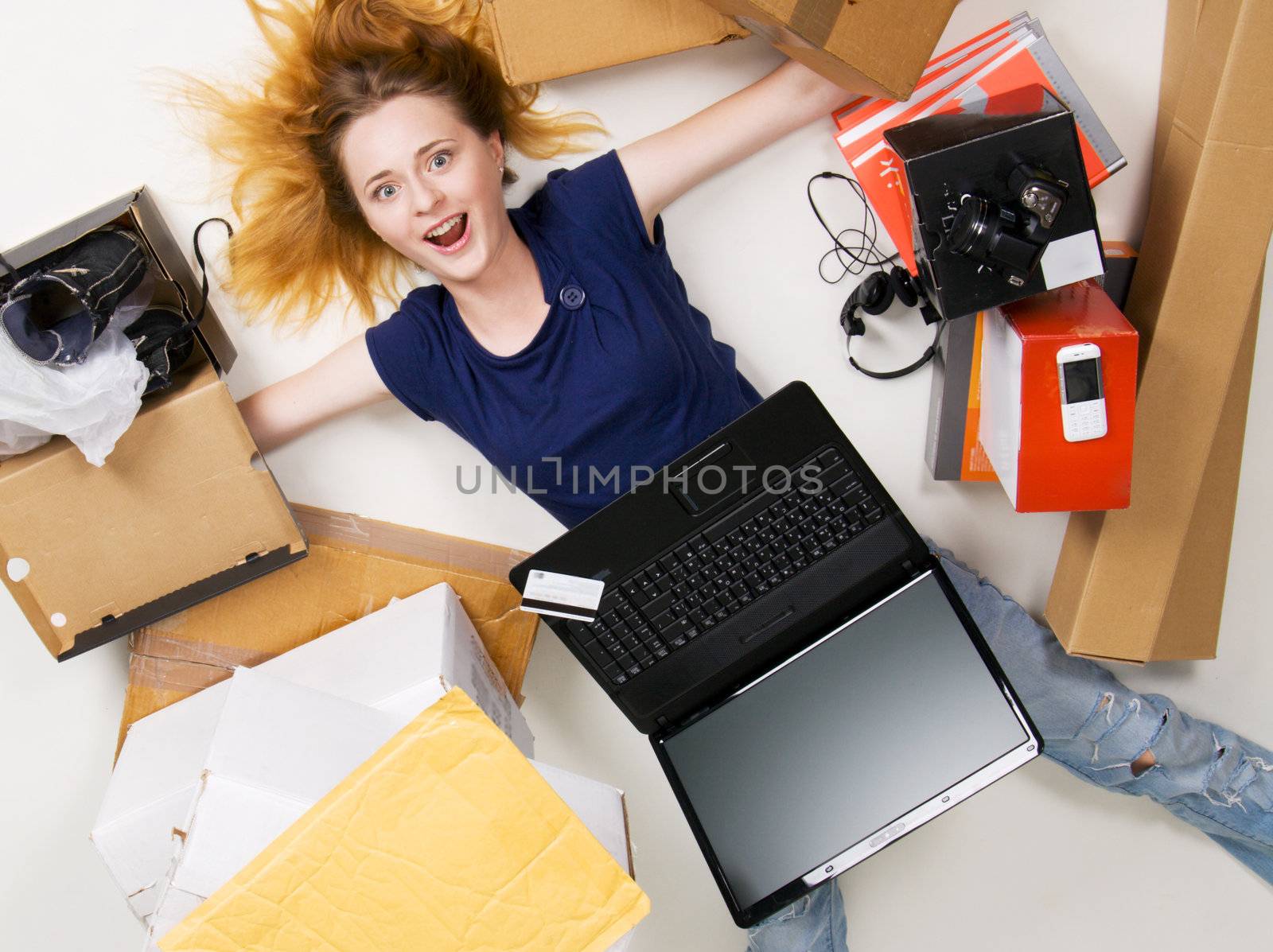 Young girl surrounded with her delivered online orders