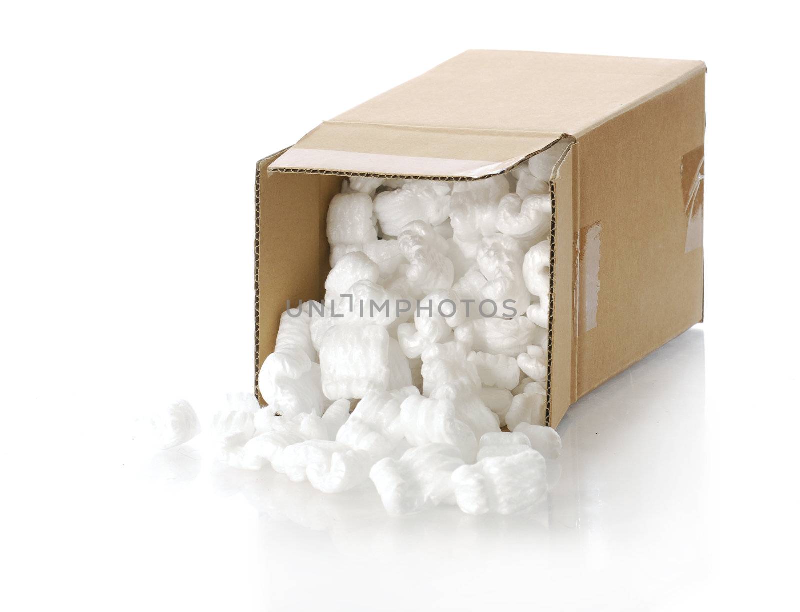 cardboard carton filled with polystyrene foam chips with reflection on white background